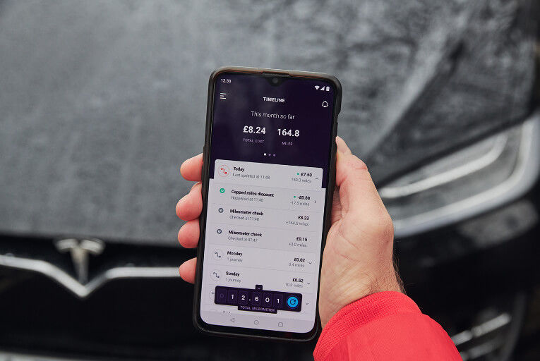 Tesla Car Insurance Smartphone App Next To Tesla Car